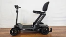 Pride Mobility Go-go Carbon Folding Scooter Open Box SC25BLK1001. Fixed Price $2895.00.