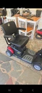 Golden Buzzaround 4-WHEEL Electric Scooter, Swivel Seat, Black/red. Fixed Price $850.00.